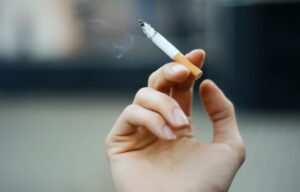 focus of a hand holding a cigarette tobacco effects dentist in Knoxville Tennessee